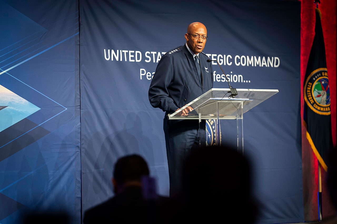 An Air Force general speaks into a microphone at a lectern.