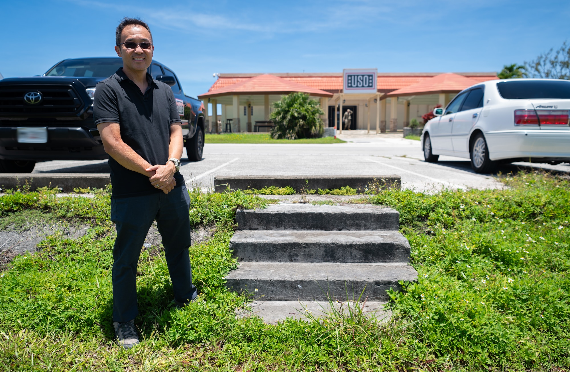 Nam Kim, University of Wisconsin-Madison Department of Anthropology professor, stands next to stone stairs at Andersen Air Force Base, Guam, August 9, 2024. These stairs are one of the last remaining remnants of "Tin City" a refugee camp that housed and processed around 40 thousand Vietnam War refugees on Andersen AFB. (U.S. Air Force photo by Staff Sgt. Pedro Tenorio)
