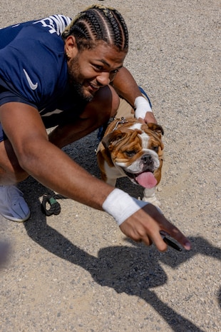 U.S. Marine Corps Lance Cpl. Bruno, the mascot of Marine Corps Recruit Depot San Diego, Western Recruiting Region, poses for a photo with a Bears player at Halas Hall, Lake Forest, Ill., Aug. 8, 2024. Lance Cpl. Bruno attended the Chicago Bears’ training camp to promote the U.S. Marine Corps, and interact with the public. (U.S. Marine Corps photo by Cpl. Reine Whitaker)