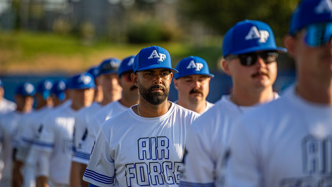 Members of the team Air Force men's softball team participate in the opening ceremony of the Department of Defense Men's and Women's softball championships at Devon Park, Oklahoma City, on Aug. 14, 2024. The 2024 Armed Forces Men’s and Women’s Softball Championship hosted by USA Softball at the USA Softball National Hall of Fame Complex from 13-19 August features Service members from the Army, Marine Corps, Navy, Air Force (with Space Force personnel) and Coast Guard.  Teams will battle it out for gold. (U.S. Air Force photo by Staff Sergeant James Crow)