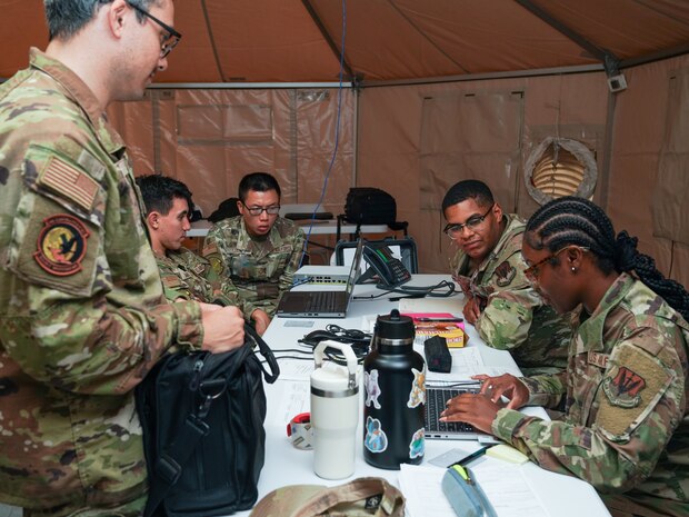 9th Reconnaissance Wing finance, personnel, and contracting specialists collaborate on a project during exercise AGILE FLAG 24-3 at Edwards Air Force Base, California, Aug. 2, 2024.