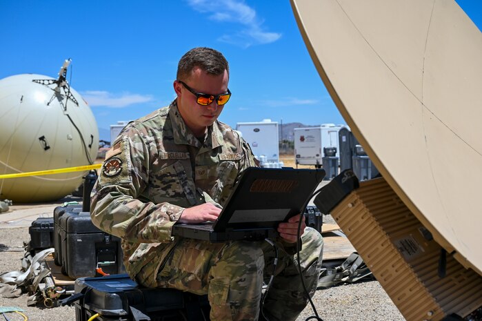 U.S. Air Force Staff Sgt. Christian McClellan, 51st Combat Communications Squadron special missions supervisor, reviews antenna systems during exercise AGILE FLAG 24-3 at March Air Reserve Base, California, Aug. 4, 2024.