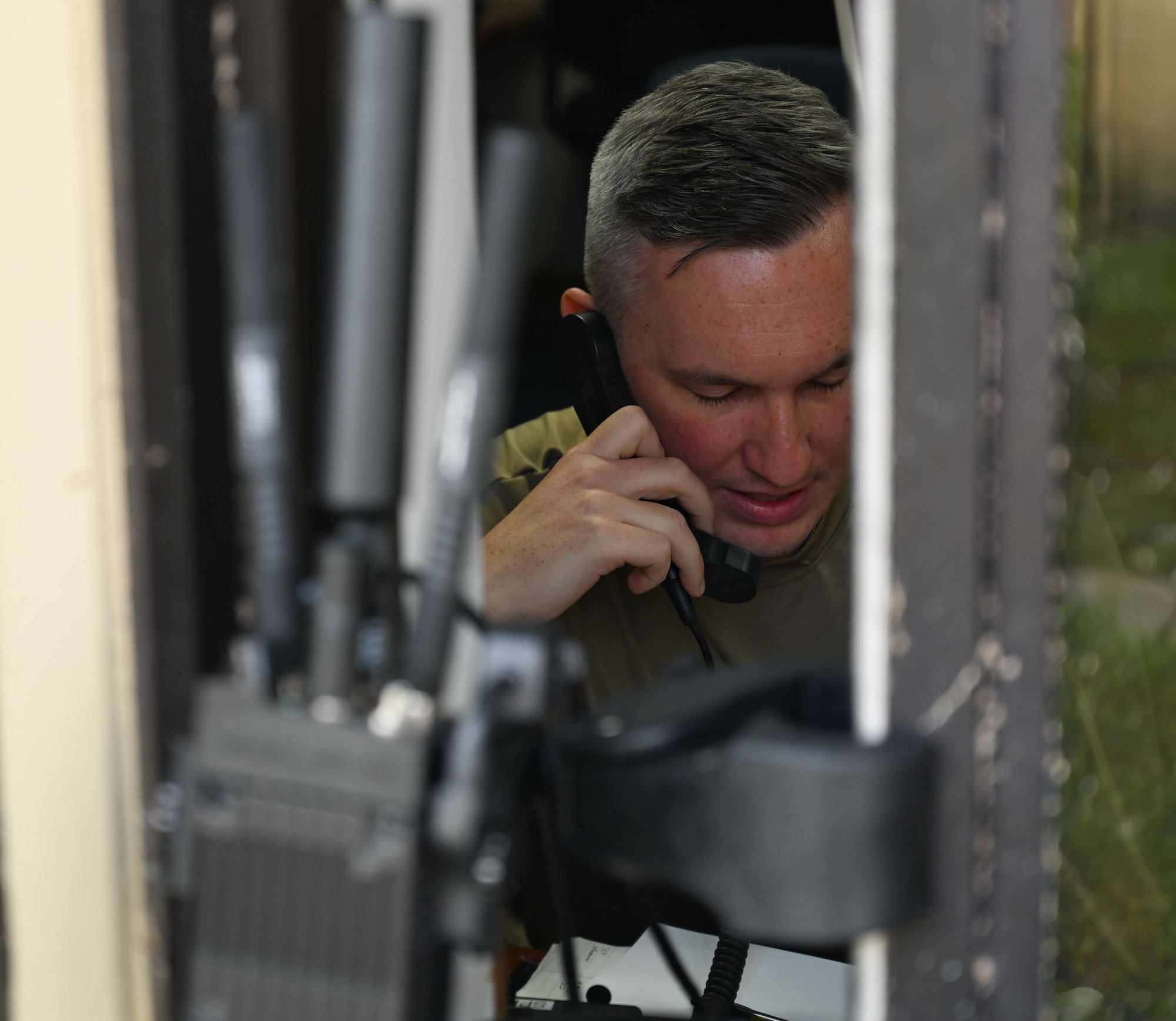 An Airman communicates with his team via radio.