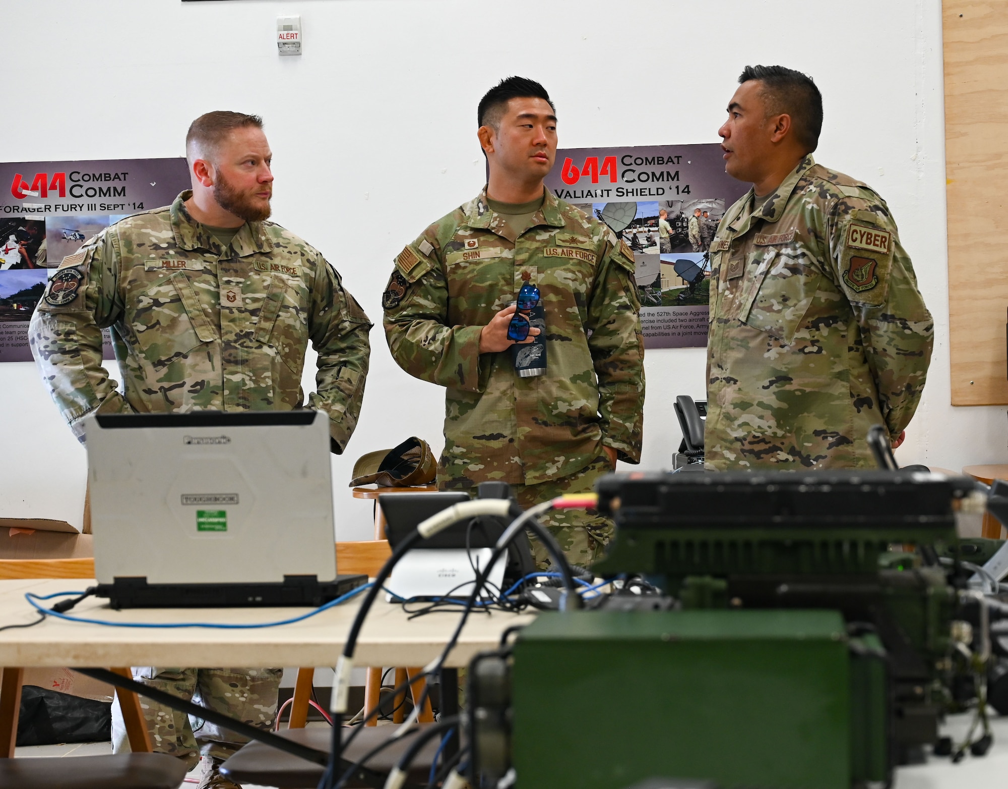 The commander of the 644th Combat Communications Squadron speaks with fellow Airmen during a field training exercise.