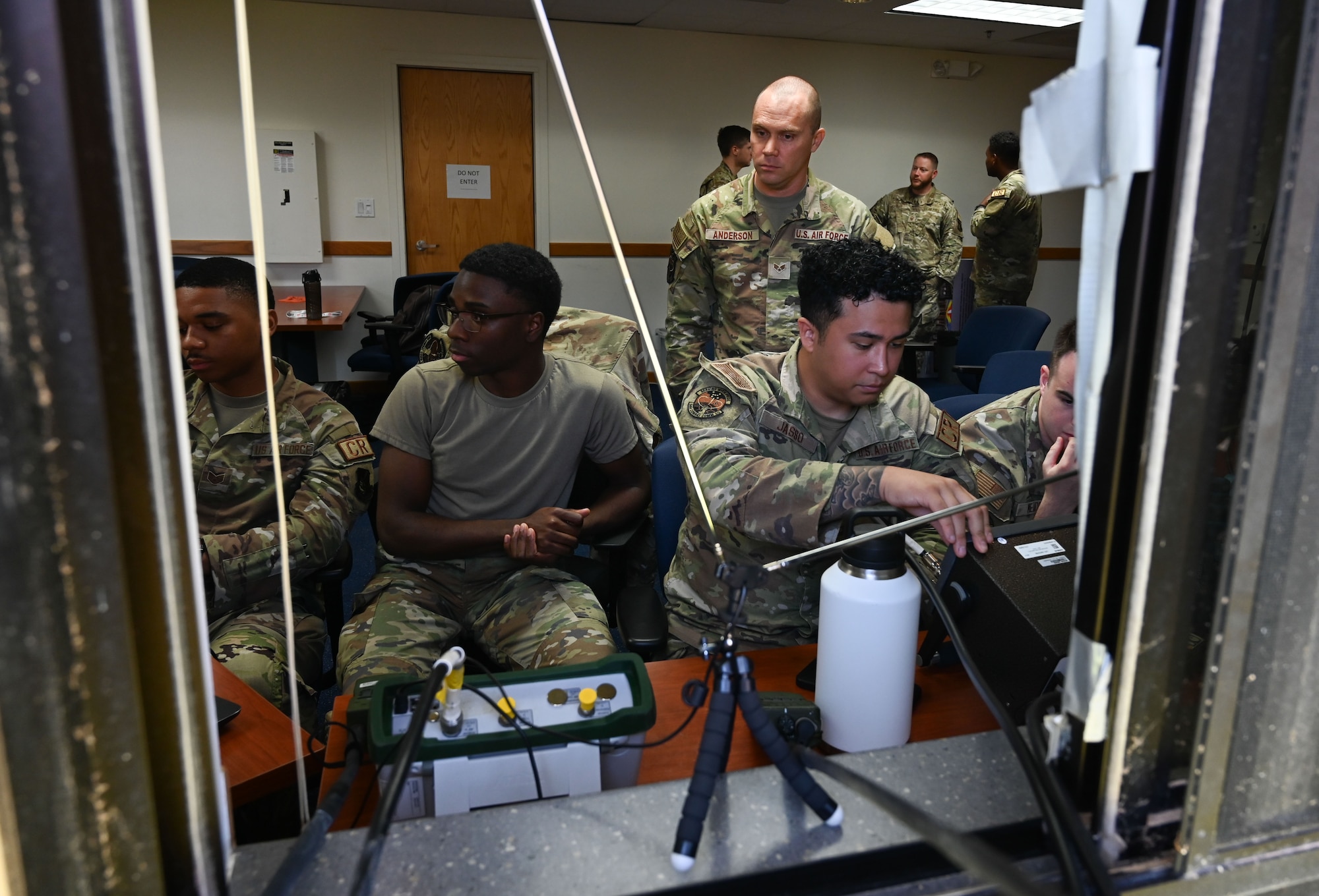 Airmen from the 644th and 293rx Combat Communications Squadron sit on chairs and listen to radio frequencies.