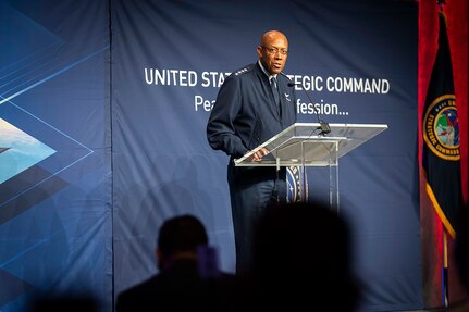 An Air Force general speaks into a microphone at a lectern.