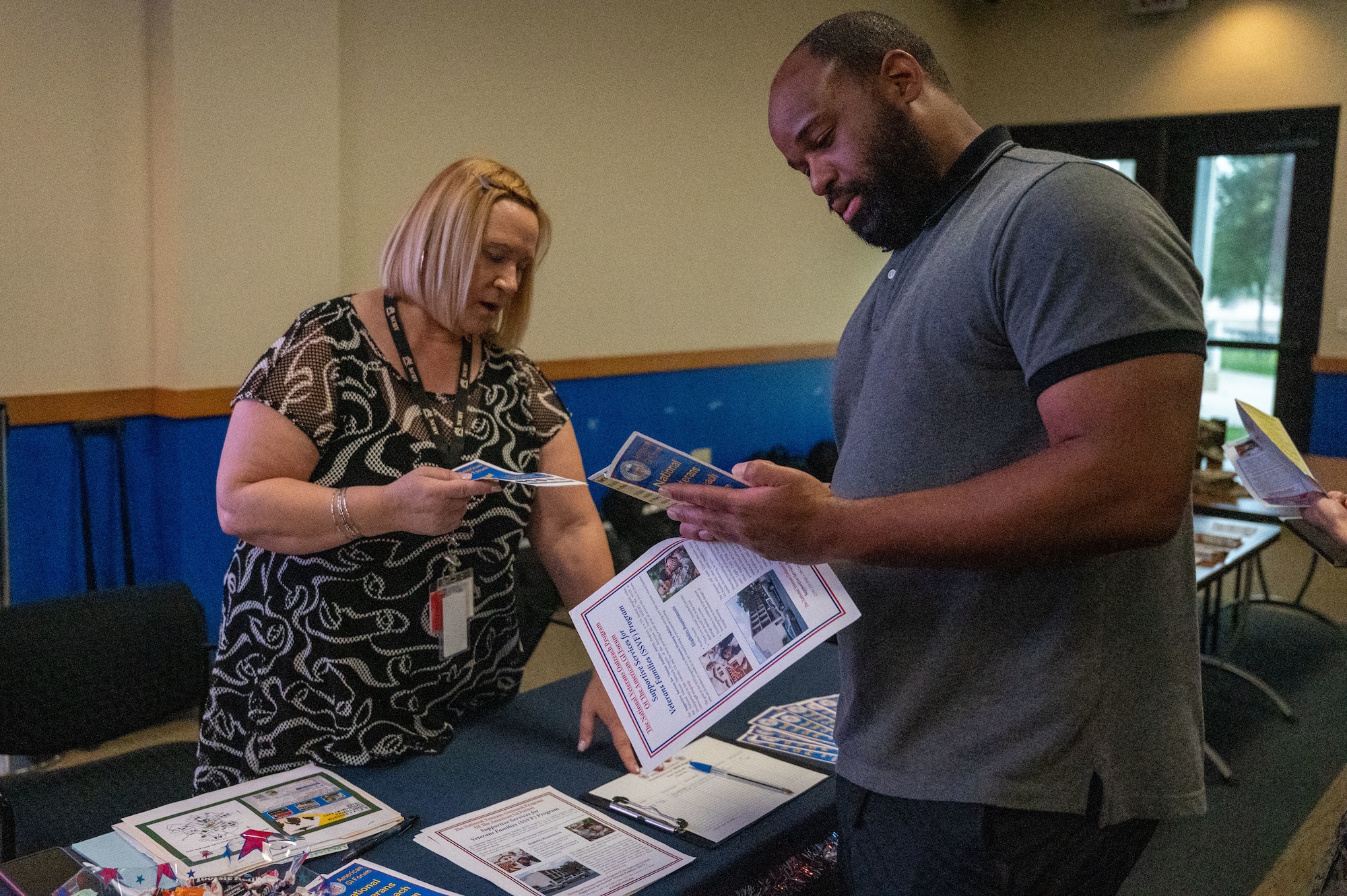 Brad Harris (right) engages with a representative (left) from the National Veterans Outreach program at the DRIVE (Develop, Redistribute, Improve, Vault, Expose) Joint Forces Employment Fast Track event on June 28, 2024, at the Pfingston Reception Center on Joint Base San Antonio-Lackland.