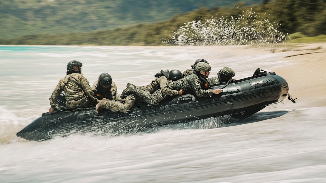 Malaysian soldiers and Mexican Naval Infantry Corps marines drive a combat rubber raiding craft onto the beach during a small boat training at Marine Corps Training Area Bellows, Waimanalo, Hawaii, during Exercise Rim of the Pacific (RIMPAC) 2024, July 17. Twenty-nine nations, 40 surface ships, three submarines, 14 national land forces, more than 150 aircraft, and 25,000 personnel are participating in and around the Hawaiian Islands June 27 to Aug. 1. The world's largest international maritime exercise; RIMPAC provides a unique training opportunity while fostering and sustaining cooperative relationships among participants critical to ensuring the safety of sea lanes and security on the world's oceans. RIMPAC 2024 is the 29th exercise in the series that began in 1971. (U.S. Marine Corps Photo by Cpl. Joseph Helms)