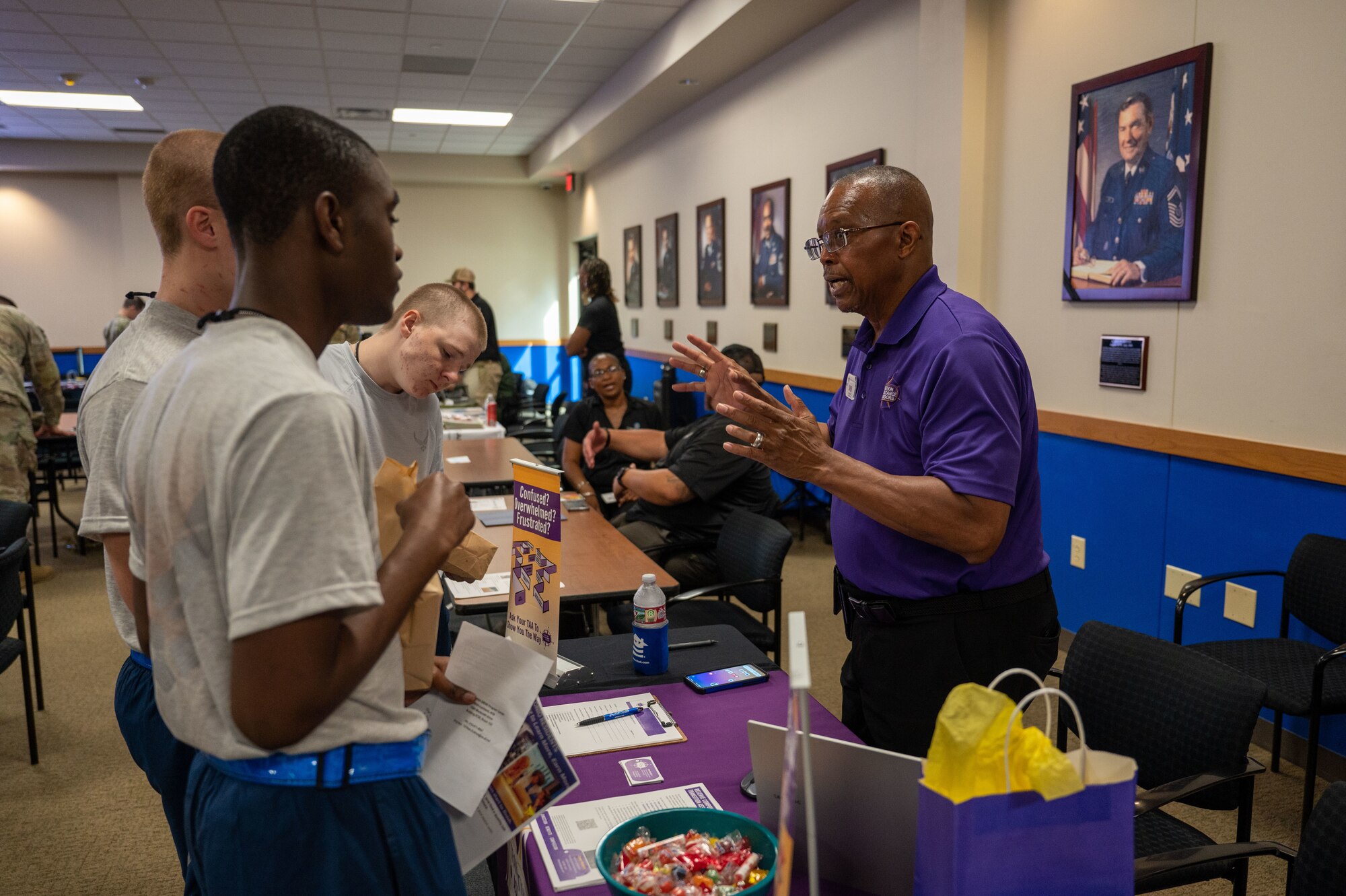 The 737th Training Group trainees (left) interact with a representative (right) at the DRIVE (Develop, Redistribute, Improve, Vault, Expose) Joint Forces Employment Fast Track event on June 28, 2024, at the Pfingston Reception Center on Joint Base San Antonio-Lackland.