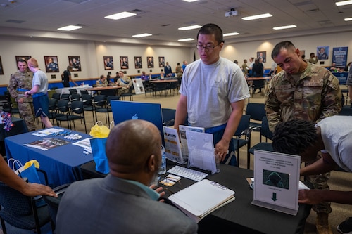 The 737th Training Group trainees (right) interact with representatives at the DRIVE (Develop, Redistribute, Improve, Vault, Expose) Joint Forces Employment Fast Track event on June 28, 2024, at the Pfingston Reception Center on Joint Base San Antonio-Lackland.
