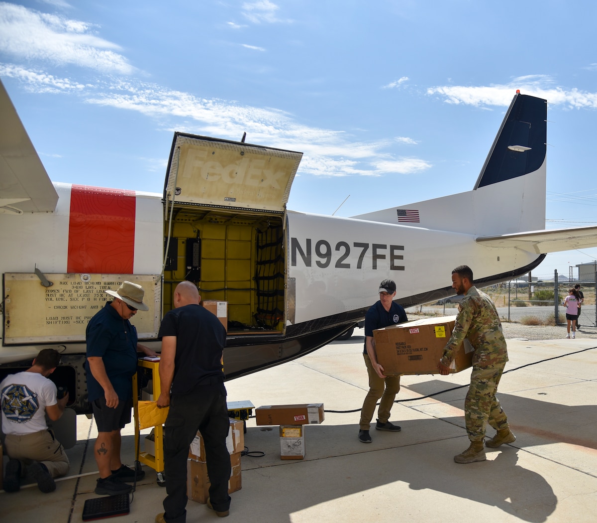 Chad Russell, AFWERX Agility Prime engineer, and Airman 1st Class Justin Lopez, a logistics readiness ground transportation specialist with the 23rd Wing, load cargo onto the autonomous Cessna 208B Grand Caravan from Reliable Robotics, an AFWERX Autonomy Prime partner, during AGILE FLAG 24-3 at Mojave Air and Space Port, Calif., Aug. 8, 2024.