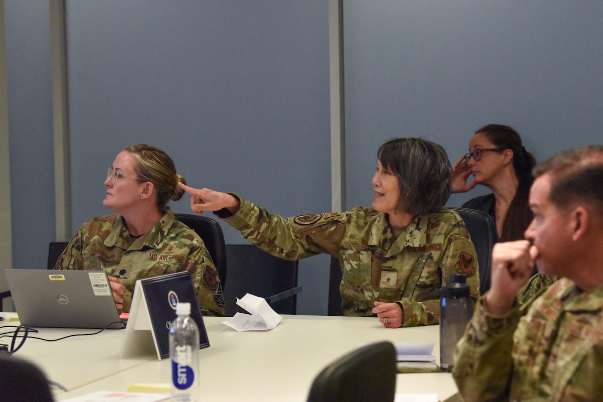 Image of Airmen attending and talking at a meeting