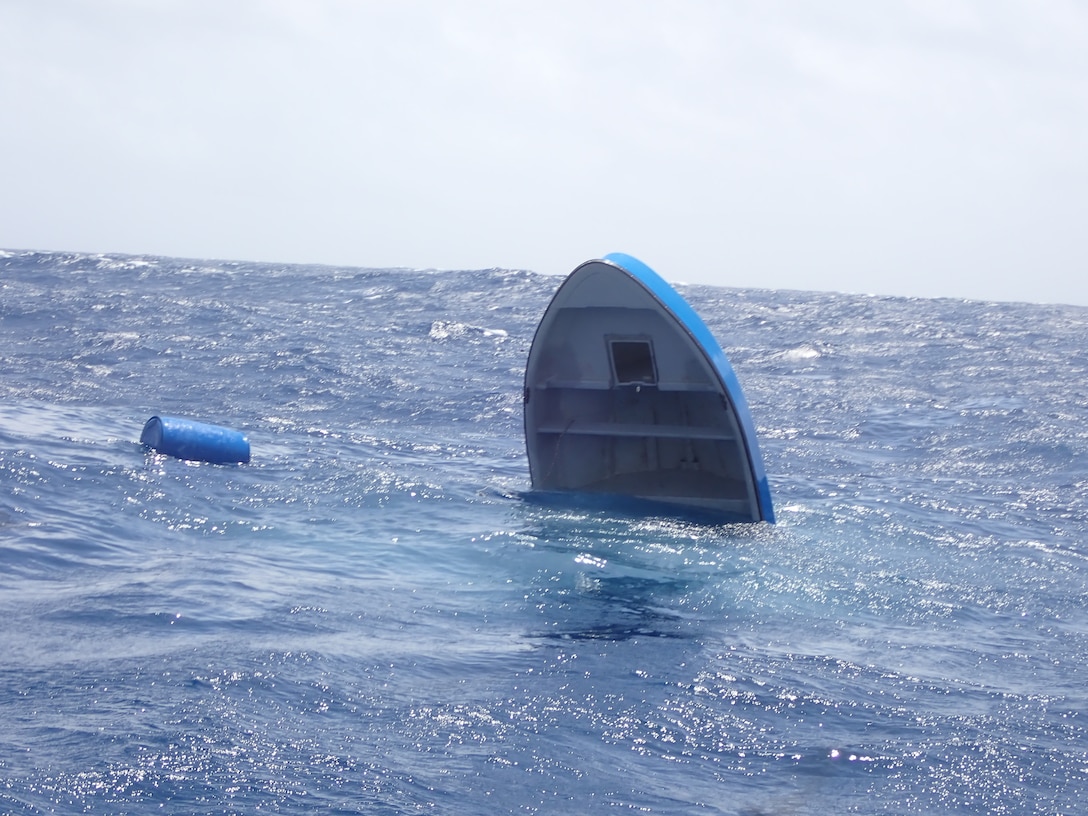 A suspected drug smuggling vessel sinking in the Caribbean sea on July 24, 2024. The alleged smugglers were rescued by small boat crews from the USS St. Louis after their vessel began taking on water. (Courtesy asset)