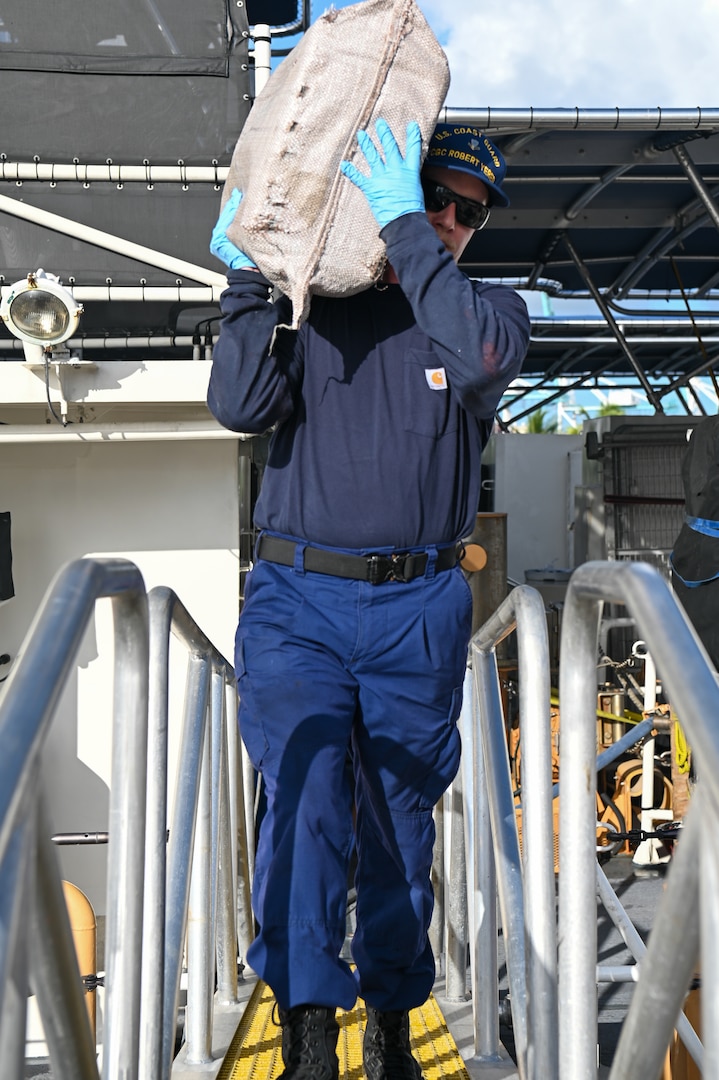 A crew member of the Coast Guard Cutter Robert Yered carries a bale of cocaine to shore for destruction at Base Miami Beach on August 14, 2024. Once ashore custody of interdicted narcotics are transferred to partner agencies. (U.S. Coast Guard photo by Petty Officer 3rd Class Nicholas Strasburg)