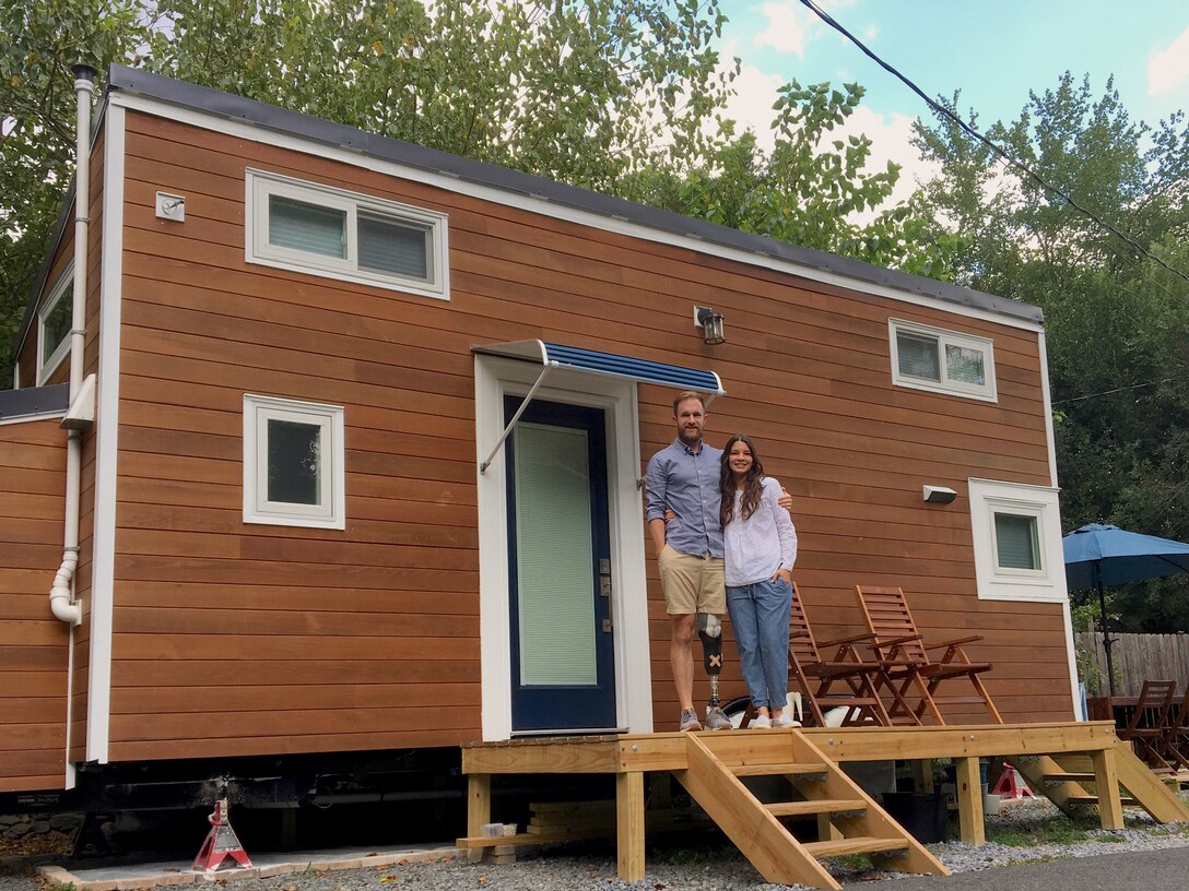 Cameron Kerr and his wife were in front of the 24-foot Tiny House on Wheels they had built