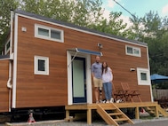 Cameron Kerr and his wife were in front of the 24-foot Tiny House on Wheels they had built