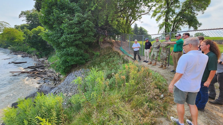 People look at shoreline erosion along Lake Ontario at Old Fort Niagara in Youngstown, N.Y.