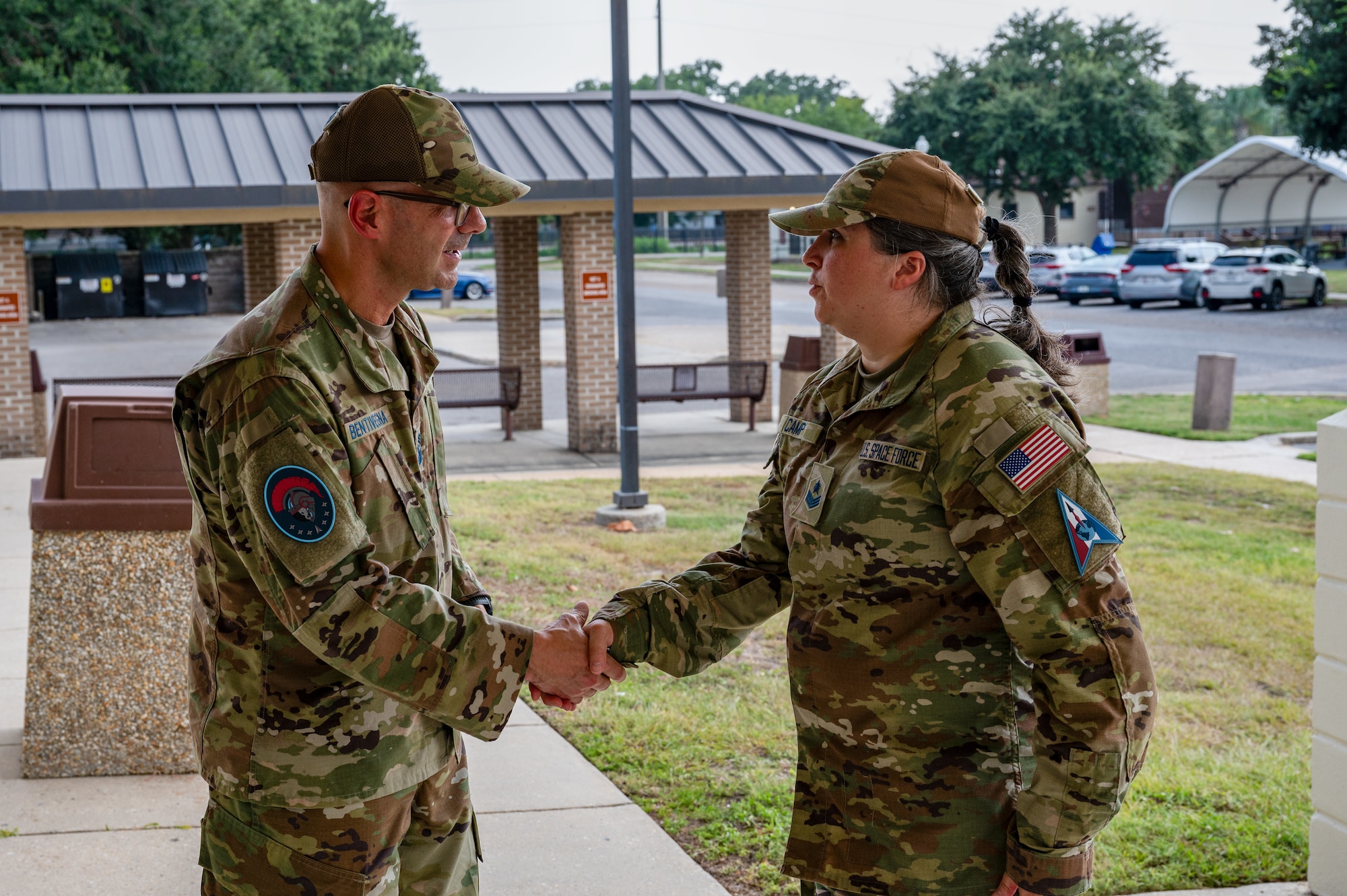 Chief Master Sergeant of the Space Force John F. Bentivegna coins Sgt. Duree Camp, 533rd Training Squadron Det 2 training manager, at Keesler Air Force Base, Mississippi, Aug. 9, 2024.