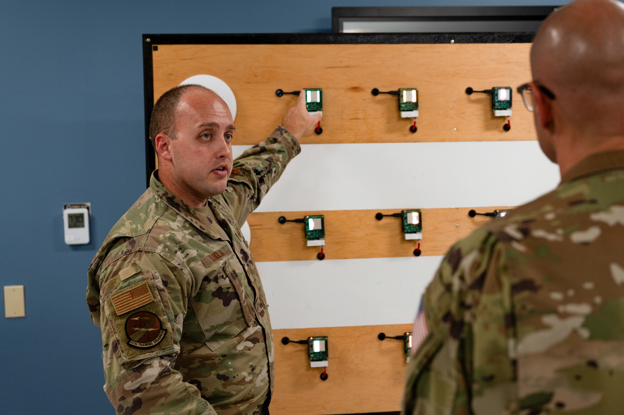 Chief Master Sergeant of the Space Force John F. Bentivegna listens to Cyber Warfare Operations Course brief by Tech. Sgt. Jessie Ludlum, 333rd Training Squadron instructor, at Keesler Air Force Base, Mississippi, Aug. 9, 2024.
