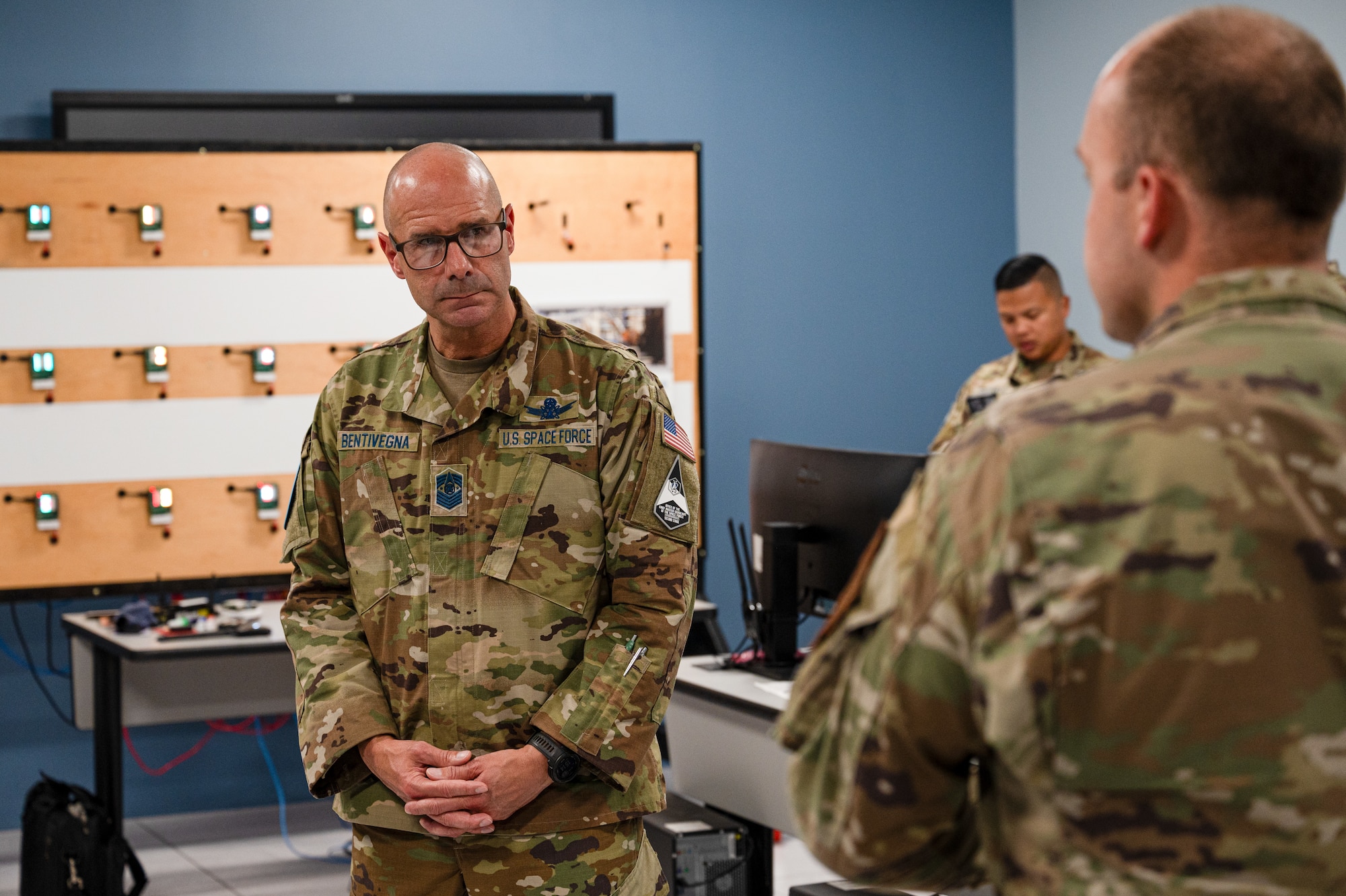 Chief Master Sergeant of the Space Force John F. Bentivegna listens to Cyber Warfare Operations Course brief by Tech. Sgt. Jessie Ludlum, 333rd Training Squadron instructor, at Keesler Air Force Base, Mississippi, Aug. 9, 2024.