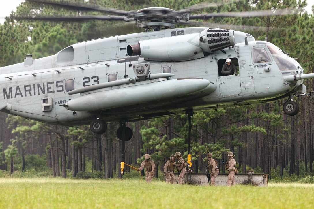 U.S. Marines with 2nd Distribution Support Battalion, Combat Logistics Regiment 2, 2nd Marine Logistics Group, attach a heavy beam to a CH-53E Super Stallion during helicopter support team operations on Camp Lejeune, North Carolina, Aug. 13, 2024. 2nd DSB conducted the training to prepare Marines to manage activities at landing zones; facilitate the pickup, movement, and landing of helicopter-borne troops, equipment, and supplies. (U.S. Marine Corps photo by Sgt. Mary Kohlmann)