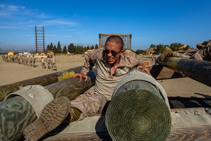 U.S Marine Corps Recruit Emilio De La Rosa, a recruit with Bravo Company, 1st Recruit Training Battalion, attempts an obstacle during a confidence course training event at Marine Corps Recruit Depot San Diego, California, Aug. 5, 2024. The confidence course challenges recruits physically and mentally through obstacles that require confidence in their strength, balance, and determination. (U.S. Marine Corps photo by Lance Cpl. Eric Valerio)