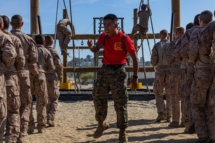 U.S Marine Corps Sgt. Harry Le, a drill instructor with Bravo Company, 1st Recruit Training Battalion, instructs recruits during a Confidence Course training event at Marine Corps Recruit Depot San Diego, California, Aug. 5, 2024. The Confidence Course challenges recruits physically and mentally through obstacles that require confidence in their strength, balance, and determination. (U.S. Marine Corps photo by Lance Cpl. Eric Valerio)