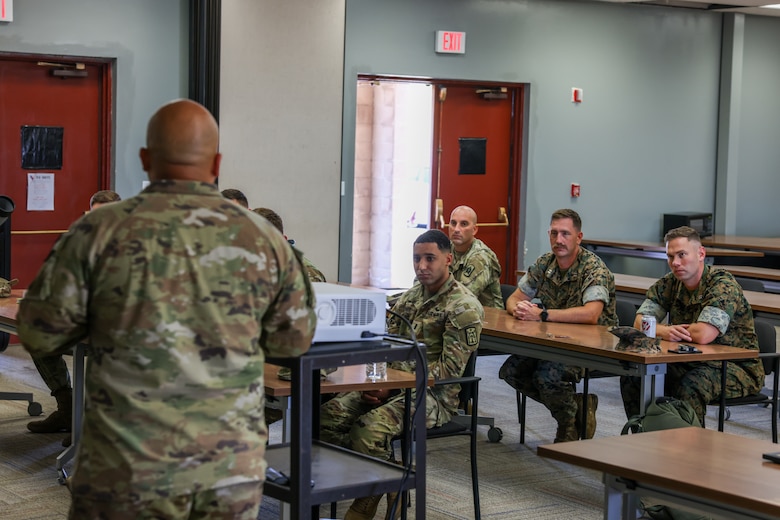 U.S. Marines and Soldiers attend an end of course discussion conducted by U.S. Army Chief Warrant Officer 3 Jesus Arellano, the Air Defense Artillery Fire Control Officer course manager with 2nd Battalion, 6th Air Defense Artillery Regiment, 30th Air Defense Brigade, at Camp Pendleton, California, July 25, 2024. Marine Air Support Squadron 3 hosted its first three-week U.S. Army ADAFCO course, with 10 soldiers and four Marines. The ADAFCO course is designed to teach and develop the necessary skills to integrate Army Air and Missile Defense engagement operations. (U.S. Marine Corps photo by Lance Cpl. Jennifer Sanchez)