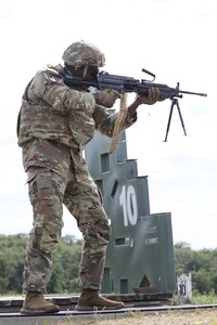 Master Sgt. Winston Allen, Weapons Non-Commissioned Officer in Charge, fires the M-249 Squad Automatic Weapon from a standing position during range qualification at Fort McCoy, Wisconsin, August 7, 2024.