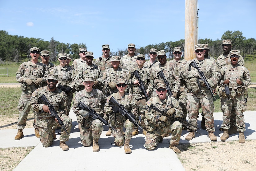 Observer coach/ trainers assigned to 1-338th Training Support Battalion, Fort McCoy, Wisconsin, shout out their unit motto ‘Badgers Marchons’ during range qualification in preparation for a stateside mobilization, August 7, 2024.