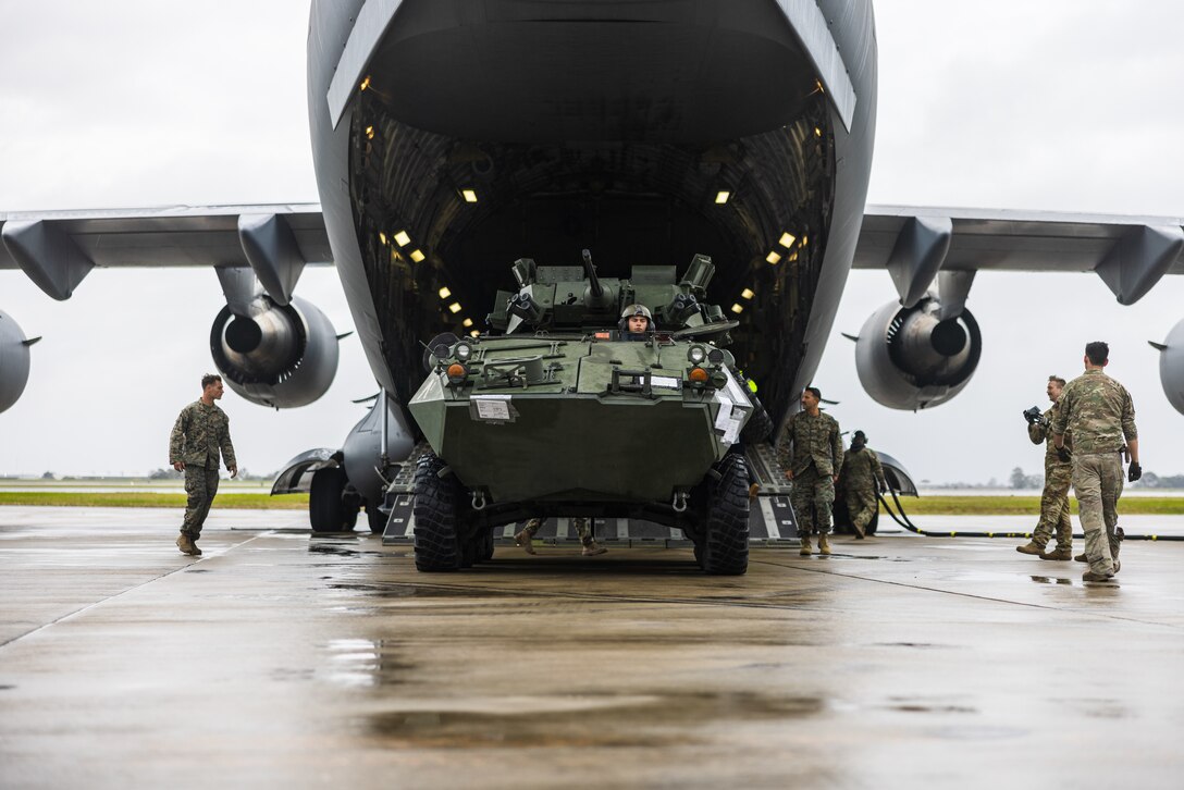 U.S. Air National Guardsman with 446th Airlift Wing, a Royal Australian Airforce Airman with 24th Squadron, and U.S. Marines with Alpha Company, 1st Light Armored Reconnaissance Battalion, 1st Marine Division, guide an LAV-25 Light Armored Vehicle out of a U.S. Air Force C-17 Globemaster III during Rapid Deployment Exercise at Royal Australian Air Force Base Edinburgh, Australia, July 11, 2024. REDEX is a 1st MARDIV training exercise, with this year’s iteration planned in conjunction with Marine Rotational Force – Darwin 24.3, to rehearse the ability to rapidly deploy capabilities from Marine Corps Base Camp Pendleton, California, U.S., to Australia. 1st LAR tested the logistical efficiency and unit readiness required to rapidly deploy a heavy equipment unit within the U.S. Indo-Pacific Command theater by strategic lift and rail to participate in Exercise Predator’s Run 24. (U.S. Marine Corps photo by Cpl. Earik Barton)
