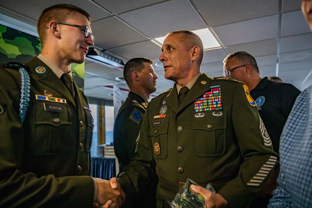 Command Sgt. Maj. John T. Raines, right, the command sergeant major of the Army National Guard, shakes hands with Spc. Tevin Kenton, an infantryman representing the Wisconsin Army National Guard, Aug. 8 at the closing ceremony of the 2024 Army National Guard Best Warrior Competition, Burlington, Vt. The Army National Guard Best Warrior Competition is a five-day event composed of 14 competitors representing the regional winners; the competition tests Soldiers’ physical and mental prowess with a series of events with the overall winners receiving either Soldier of the Year or Non-commissioned Officer of the Year recognition. U.S. Army National Guard photo by Sgt. Lianne M. Hirano