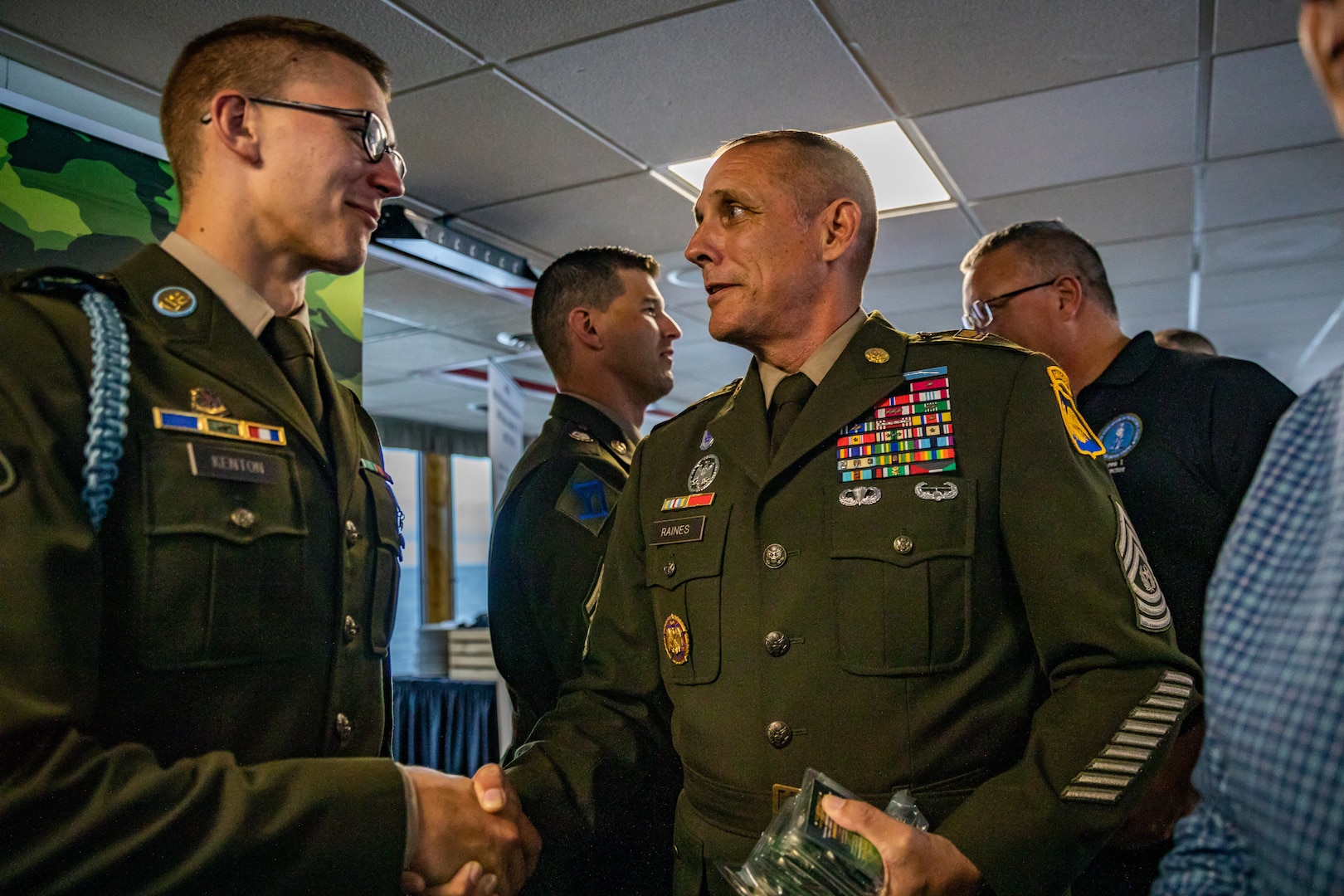 Command Sgt. Maj. John T. Raines, right, the command sergeant major of the Army National Guard, shakes hands with Spc. Tevin Kenton, an infantryman representing the Wisconsin Army National Guard, Aug. 8 at the closing ceremony of the 2024 Army National Guard Best Warrior Competition, Burlington, Vt. The Army National Guard Best Warrior Competition is a five-day event composed of 14 competitors representing the regional winners; the competition tests Soldiers’ physical and mental prowess with a series of events with the overall winners receiving either Soldier of the Year or Non-commissioned Officer of the Year recognition. U.S. Army National Guard photo by Sgt. Lianne M. Hirano