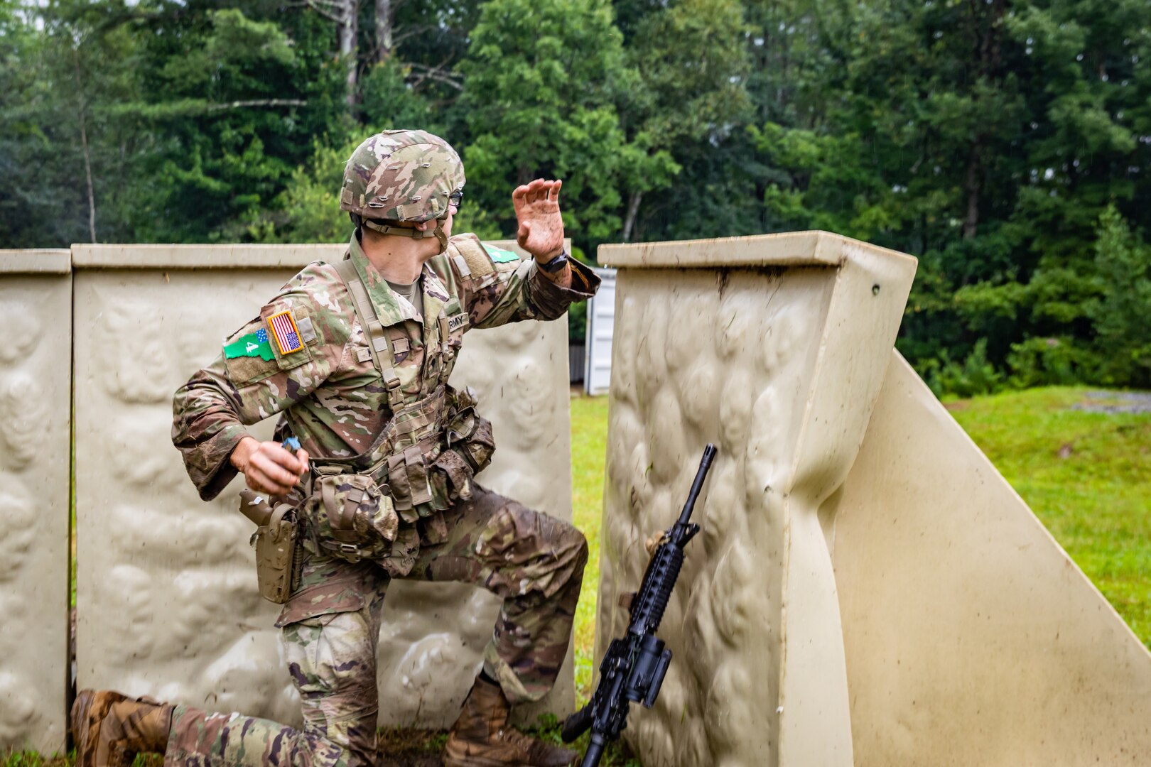 Spc. Tevin Kenton, an infantryman representing the Wisconsin National Guard  prepares to throw a hand grenade Aug. 5 at the Army Warriors Task lanes during the 2024 Army National Guard Best Warrior Competition at the Army Mountain Warfare School, Jericho, Vt. The Army National Guard Best Warrior Competition is a five-day event composed of 14 competitors representing the regional winners; the competition tests Soldiers’ physical and mental prowess with a series of events with the overall winners receiving either Soldier of the Year or Non-commissioned Officer of the Year recognition. U.S. Army National Guard photo by Sgt. Lianne M. Hirano