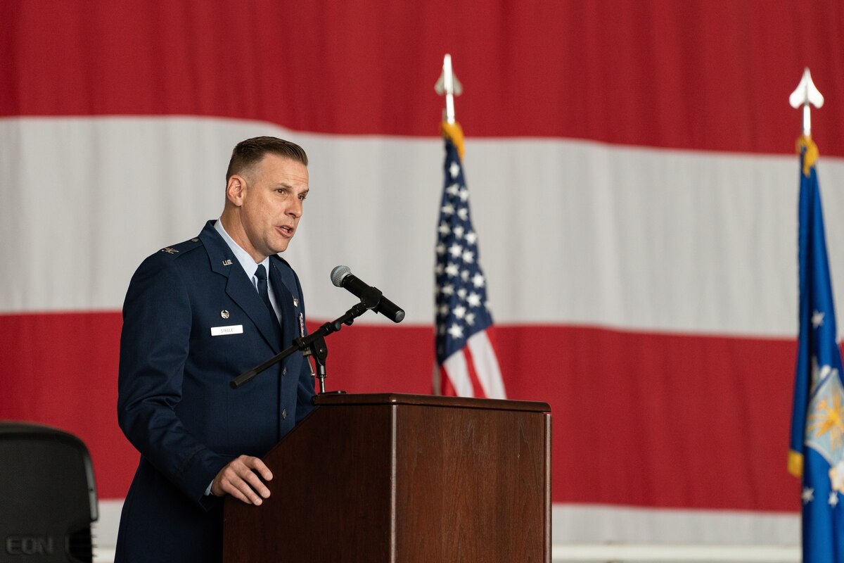An Airman speaks at a podium