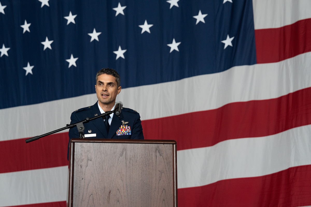 An Airman speaking at a podium