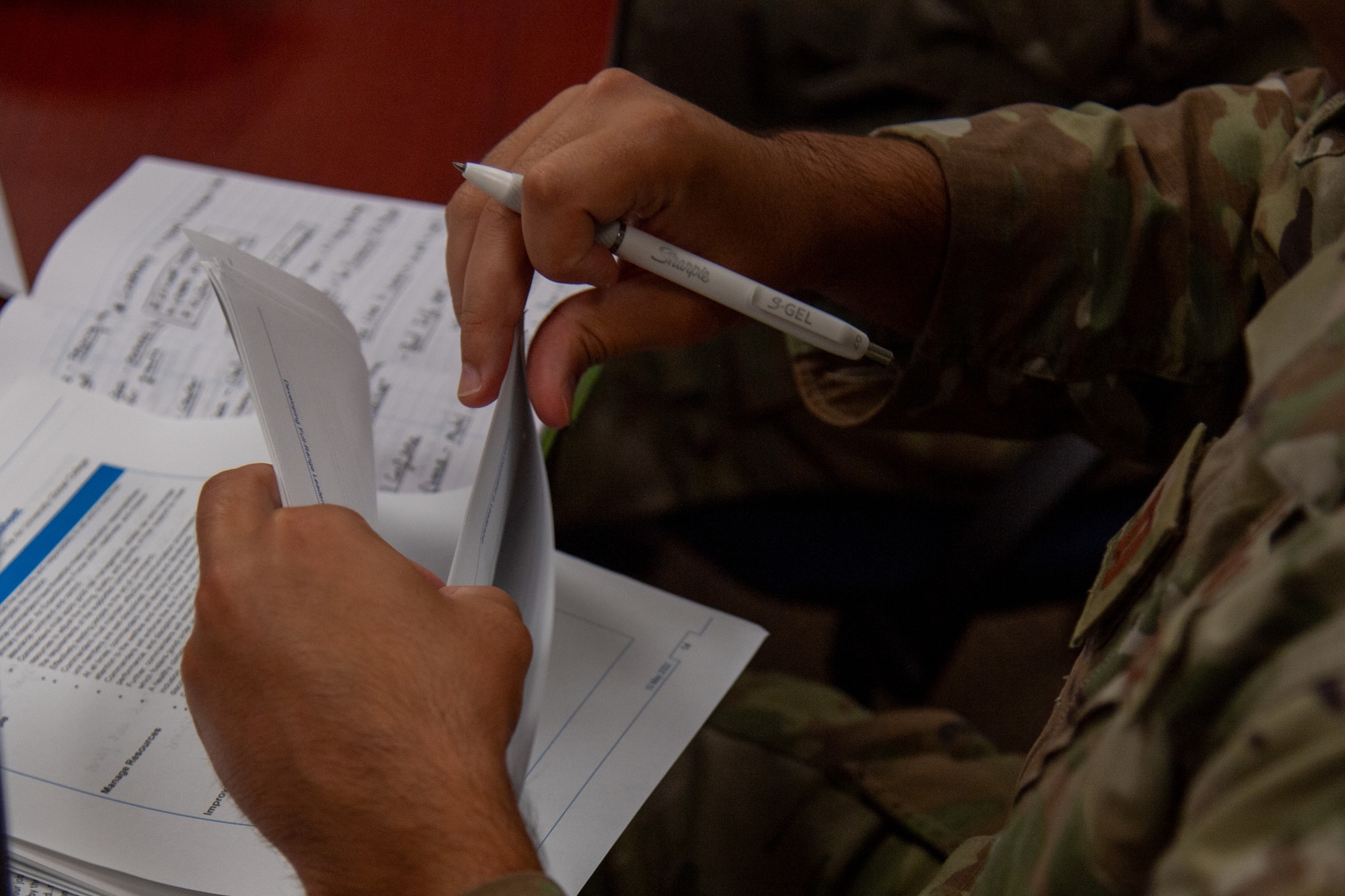 A U.S. Air Force company grade officer from the 23rd Wing takes notes during a flight commander course at Moody Air Force Base, Georgia, Aug. 1, 2024. The course addressed the unique challenges of leadership at Moody AFB, with presenters bringing diverse perspectives. (U.S. Air Force photo by Airman 1st Class Cade Ellis)