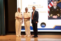 240816-N-LT766-0043 WASHINGTON -- Naval Sea Systems Command (NAVSEA) Commander Vice Adm. Jim Downey (left) and Executive Director Chris Miller (right) recognize Capt. Jonahan Garcia as recipient of NAVSEA's Excellence in Acquisition Award. A total of 304 nominations were received with 25 individual and 21 team winners named, each making significant contributions to the NAVSEA mission.