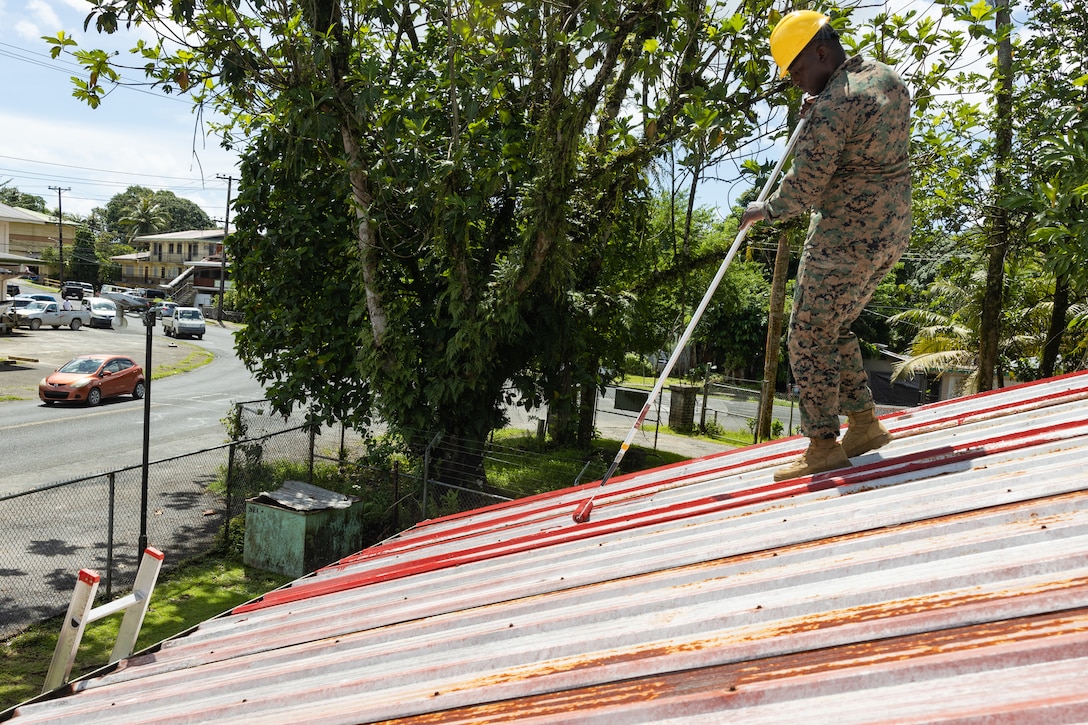 U.S. Marine Corps Sgt. Folly Amouzougan, an automotive maintenance technician with 1st Marine Logistics Group paints the Pohnpei Public Library roof during exercise Koa Moana 24 at Kolonia, Pohnpei, the Federated States of Micronesia, July 15, 2024. During Koa Moana’s deployment throughout the Indo-Pacific region, U.S. Marines and Sailors from I Marine Expeditionary Force work to strengthen alliances and partnerships with development of interoperable capabilities, combined operations, theater security cooperation, and capacity-building efforts.
