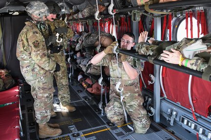 U.S. Air Force medics from the 127th Medical Group, Michigan Air National Guard, load a litter on a U.S. Army CH-47 from the 3rd Battalion, 238th General Support Aviation Regiment, Michigan Army National Guard, during Exercise Northern Strike 2024-2 at the Alpena Combat Readiness Training Center, Michigan, Aug. 11, 2024.