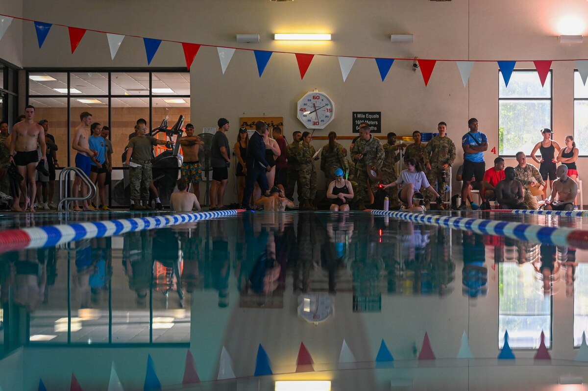 Swimmers prepare for the first phase of the base olympics at Davis-Monthan Air Force Base, Ariz., Aug. 14, 2024. The combined teams needed to finish first in a 1,000 meter swim before beginning the next event. (U.S. Air Force photo by Senior Airman Andrew Garavito)