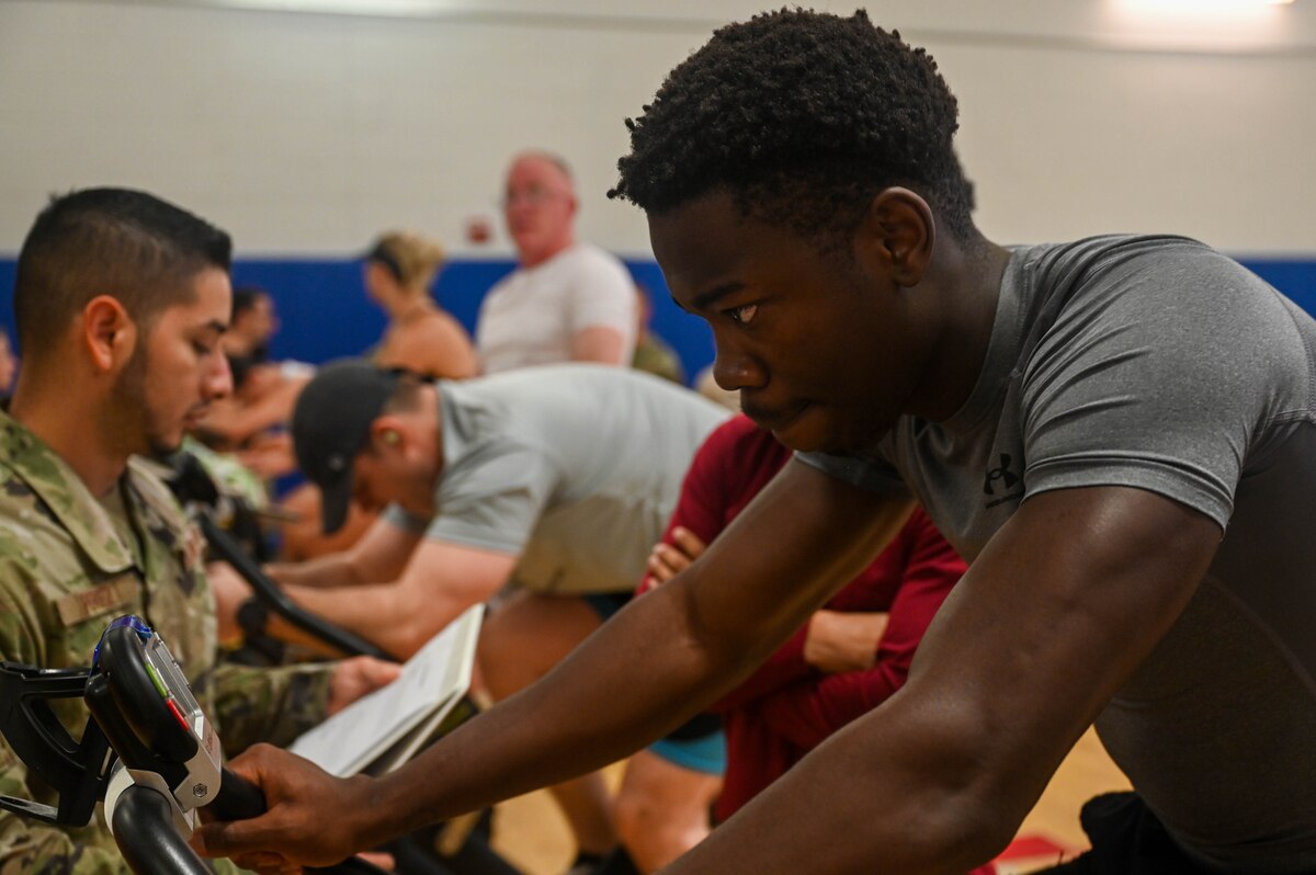 U.S. Air Force Airman 1st Class Boaz Norelien, 55th Rescue Generation Squadron crew chief, leads his team during the biking portion of the base olympics at Davis-Monthan Air Force Base, Ariz., Aug. 14, 2024. Only two members from a single team can participate in each of the three events. (U.S. Air Force photo by Senior Airman Andrew Garavito)