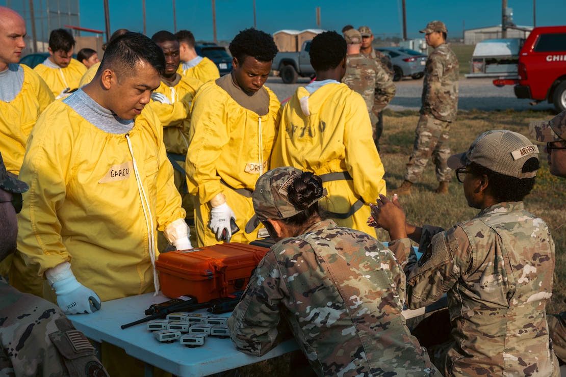 Bioenvironmental engineering specialists issue electronic personal dosimeters to the emergency management support team during exercise Bayou Guarantee at Barksdale Air Force Base, La., August 14, 2024. Exercise Bayou Guarantee provides an opportunity for Airmen to practice and simulate their response to major incidents involving Department of Defense assets that could occur on or near Barksdale Air Force Base. (U.S. Air Force Photo by Senior Airman Seth Watson)