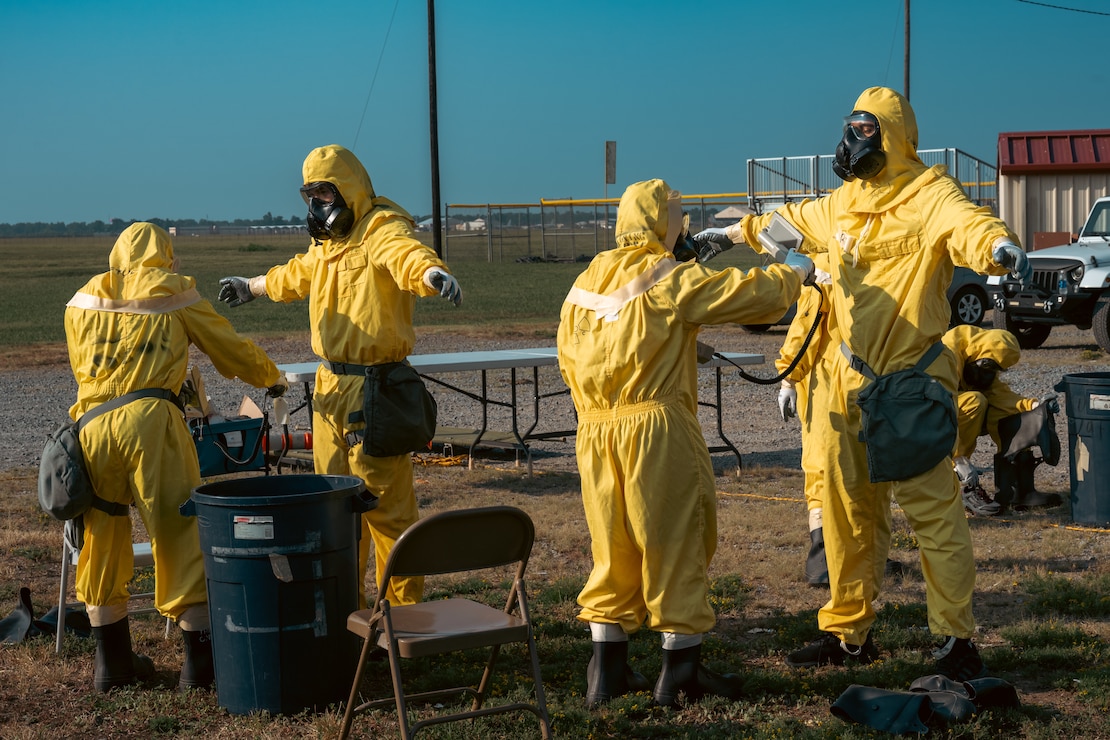 Airmen from the emergency management support team scan each other for radioactive contamination during exercise Bayou Guarantee at Barksdale Air Force Base, La., August 14, 2024. During exercise Bayou Guarantee, participants are tasked with responding to a simulated major incident on or off base involving Department of Defense assets. (U.S. Air Force Photo by Senior Airman Seth Watson)