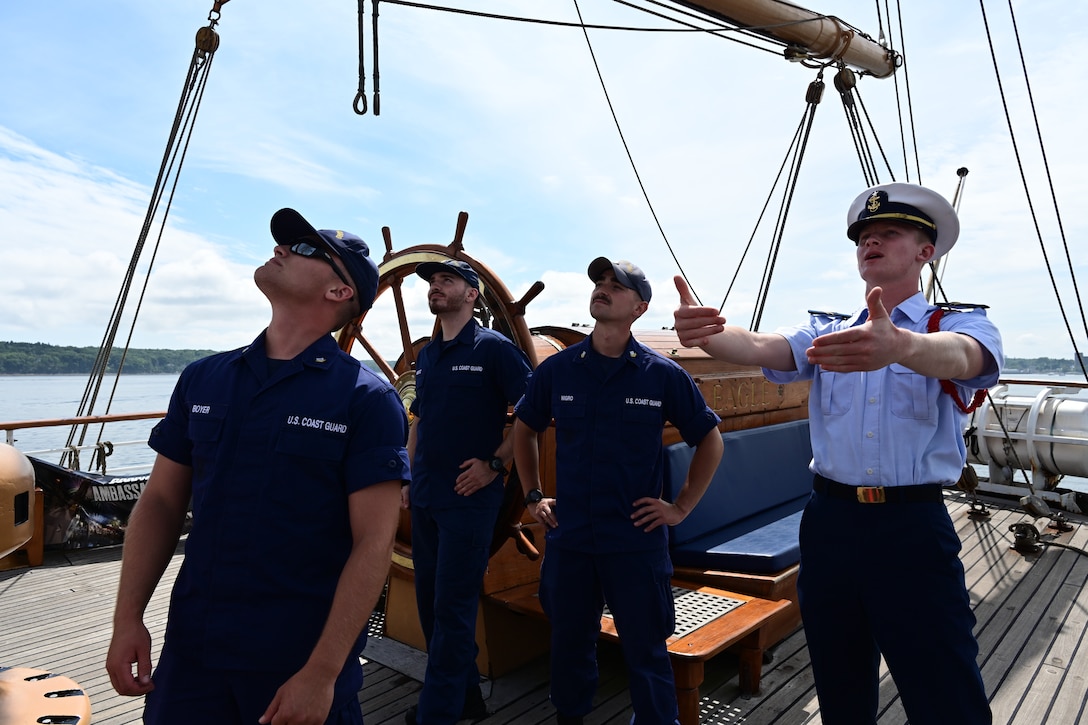 A U.S. Coast Guard Academy cadet gives a tour of Coast Guard Cutter Eagle (WIX 327) to crewmembers from Coast Guard Station Rockland, in Rockland, Maine, Aug. 3, 2024. Eagle's primary mission is training cadets and officer candidates.