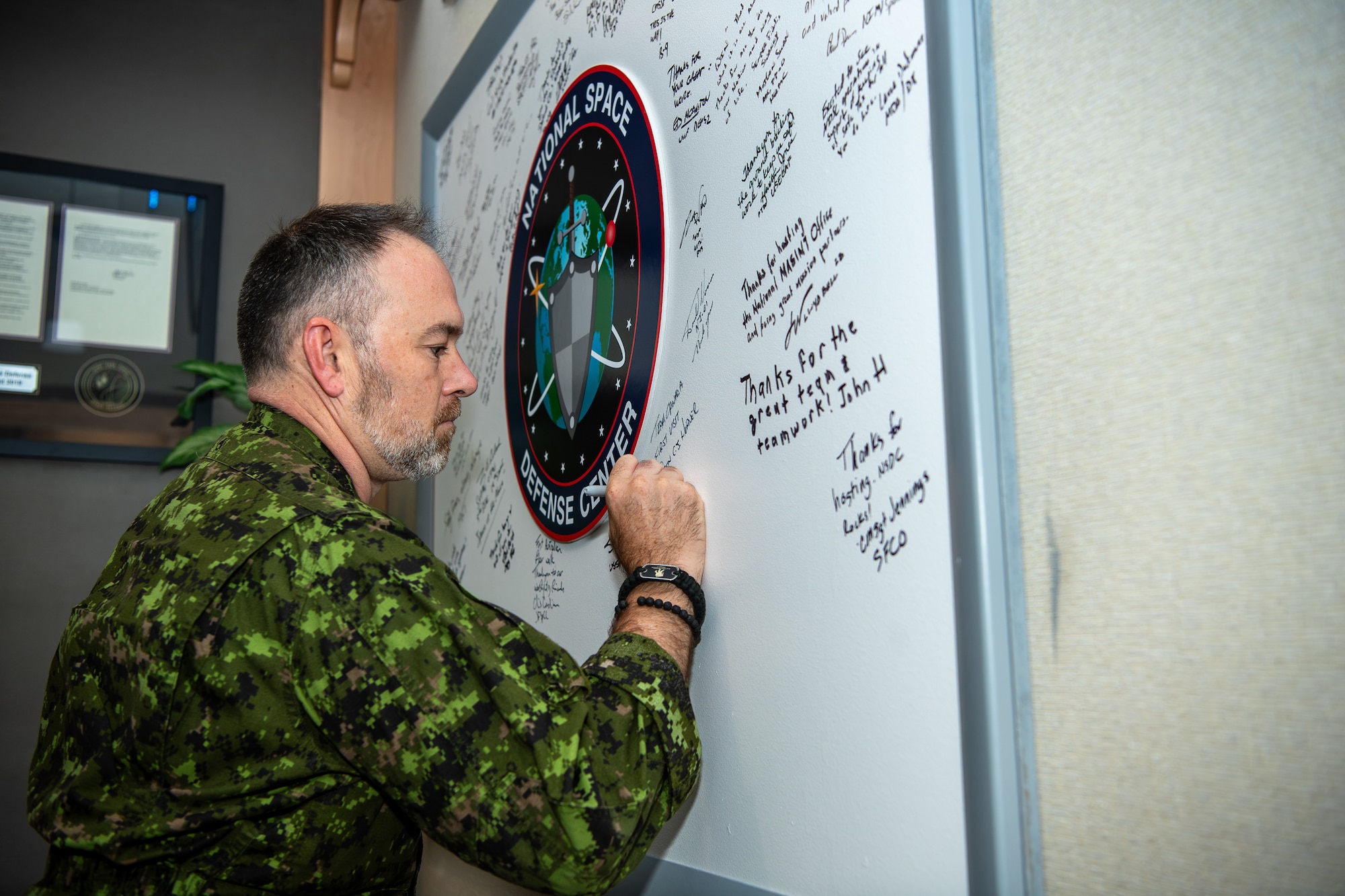 Soldier signs whiteboard