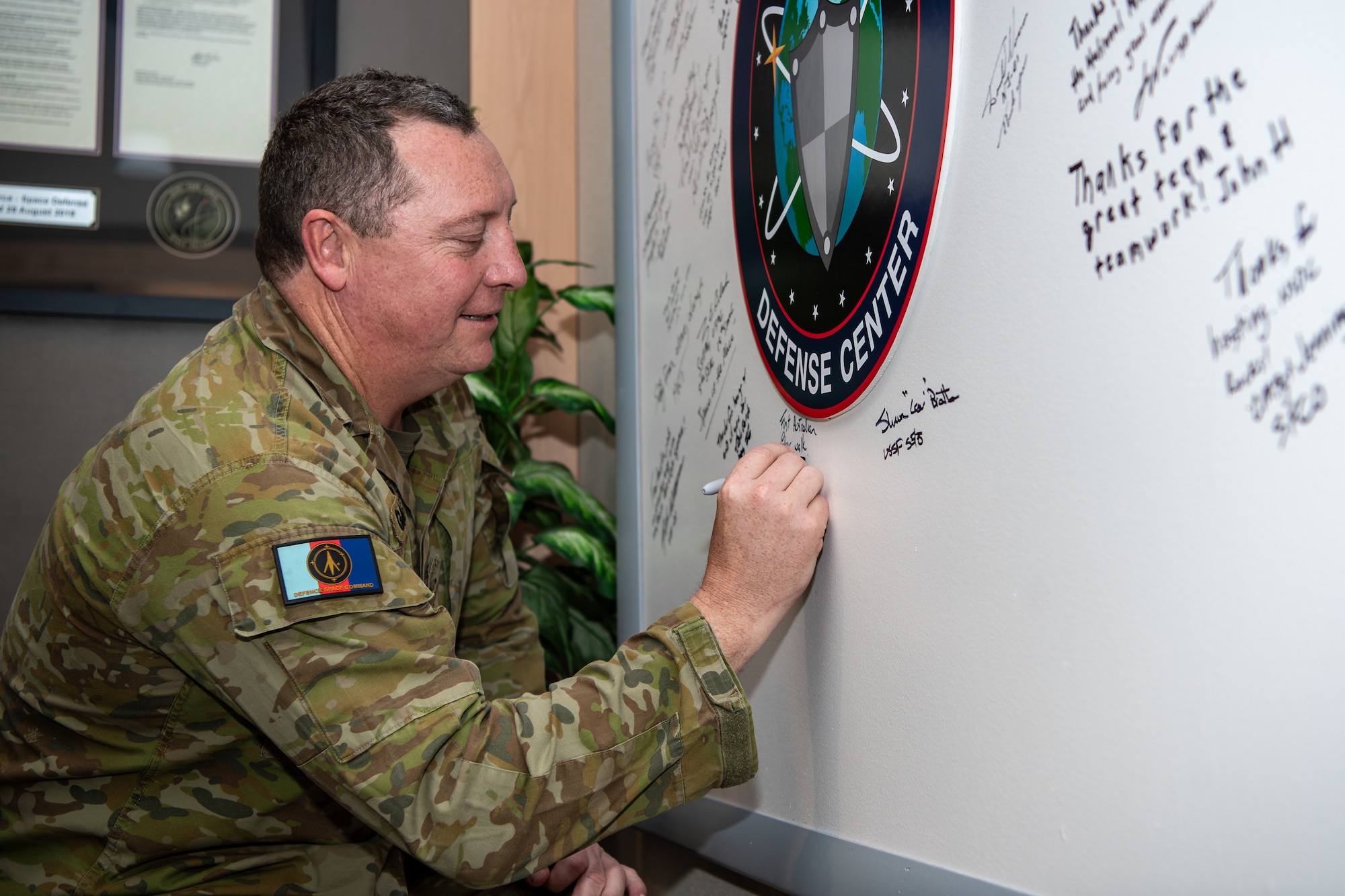 Soldier signs whiteboard.