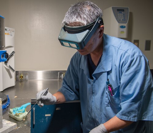A person wearing specialized equipment creating a dental mold