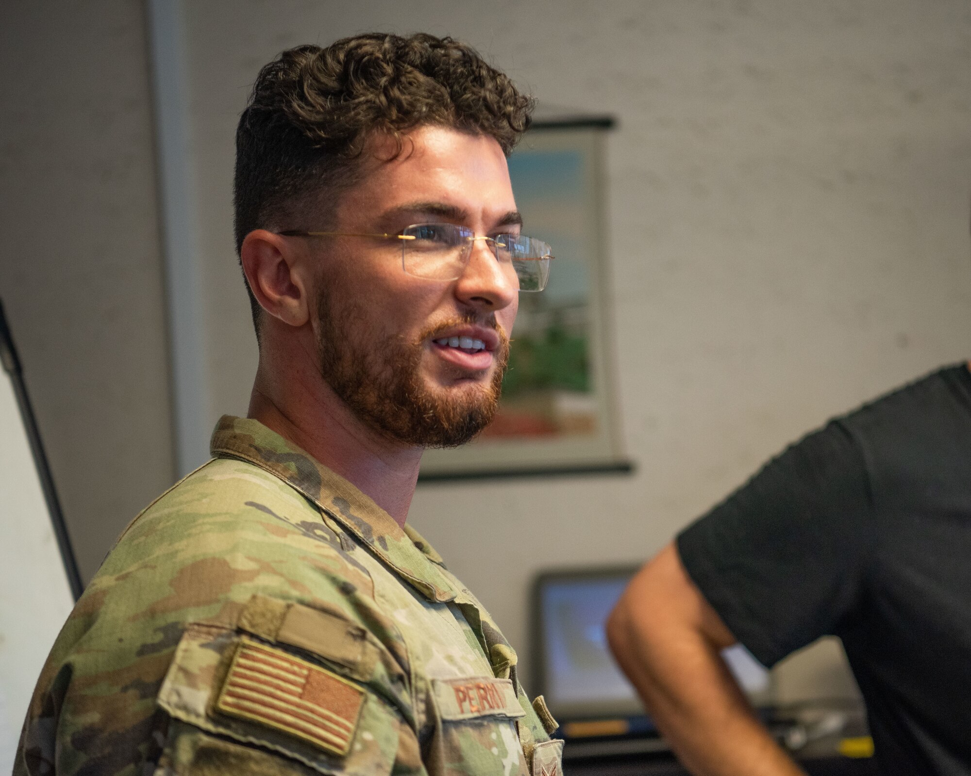 A military member speaks inside a classroom.