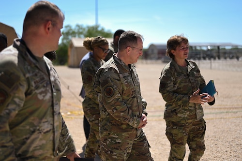 U.S. Air Force Vice Chief of Staff Gen. Jim Slife walks with Col. Angelina Maguinness, 17th Training Wing commander, Lt. Col. Benjamin Williams, 313th Training Squadron commander, and other base leadership while visiting the Joint All-Domain Expeditionary Forward Operations Readiness Exercise site during his visit, Goodfellow Air Force Base, Texas, Aug. 14, 2023. JADE FORGE immerses joint service intelligence professionals in a simulated operational environment, enabling them to apply essential intelligence functions—analysis, collection, integration, and targeting—in a realistic setting. (U.S. Air Force photo by Airman 1st Class Madi Collier)